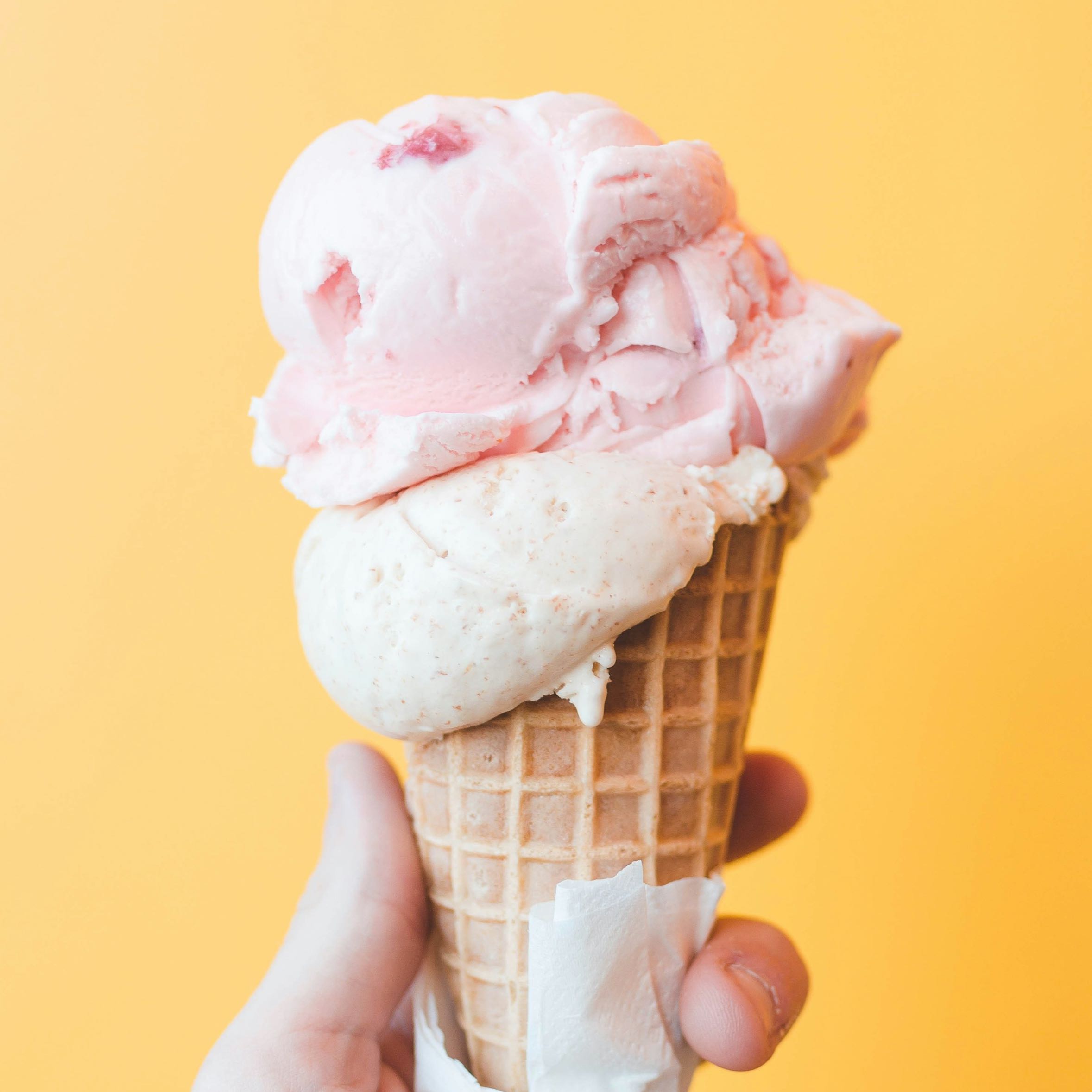 A person hold an ice-cream cone