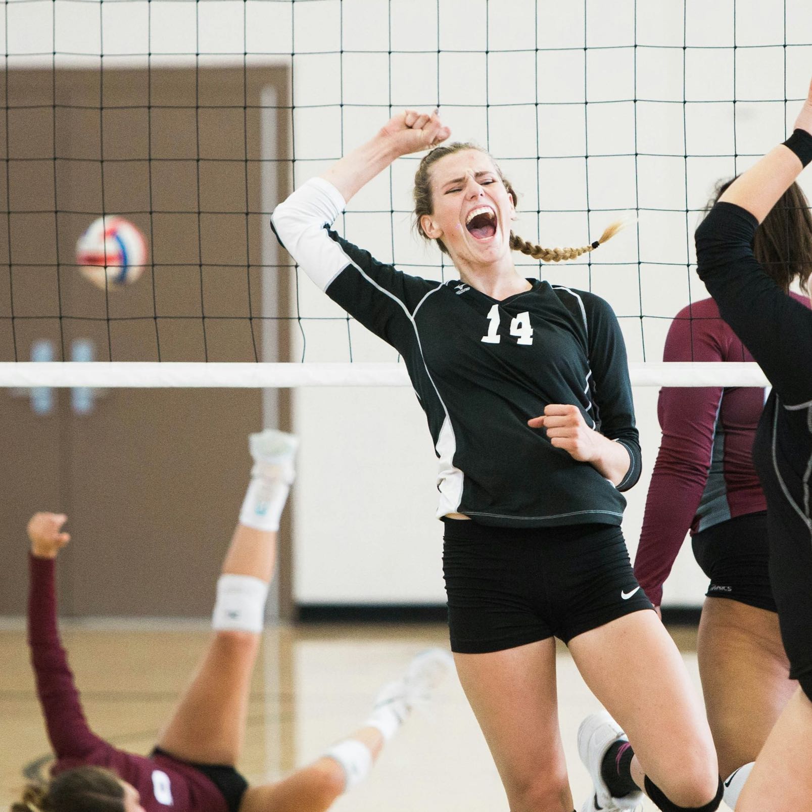 A group of girls playing volleyball